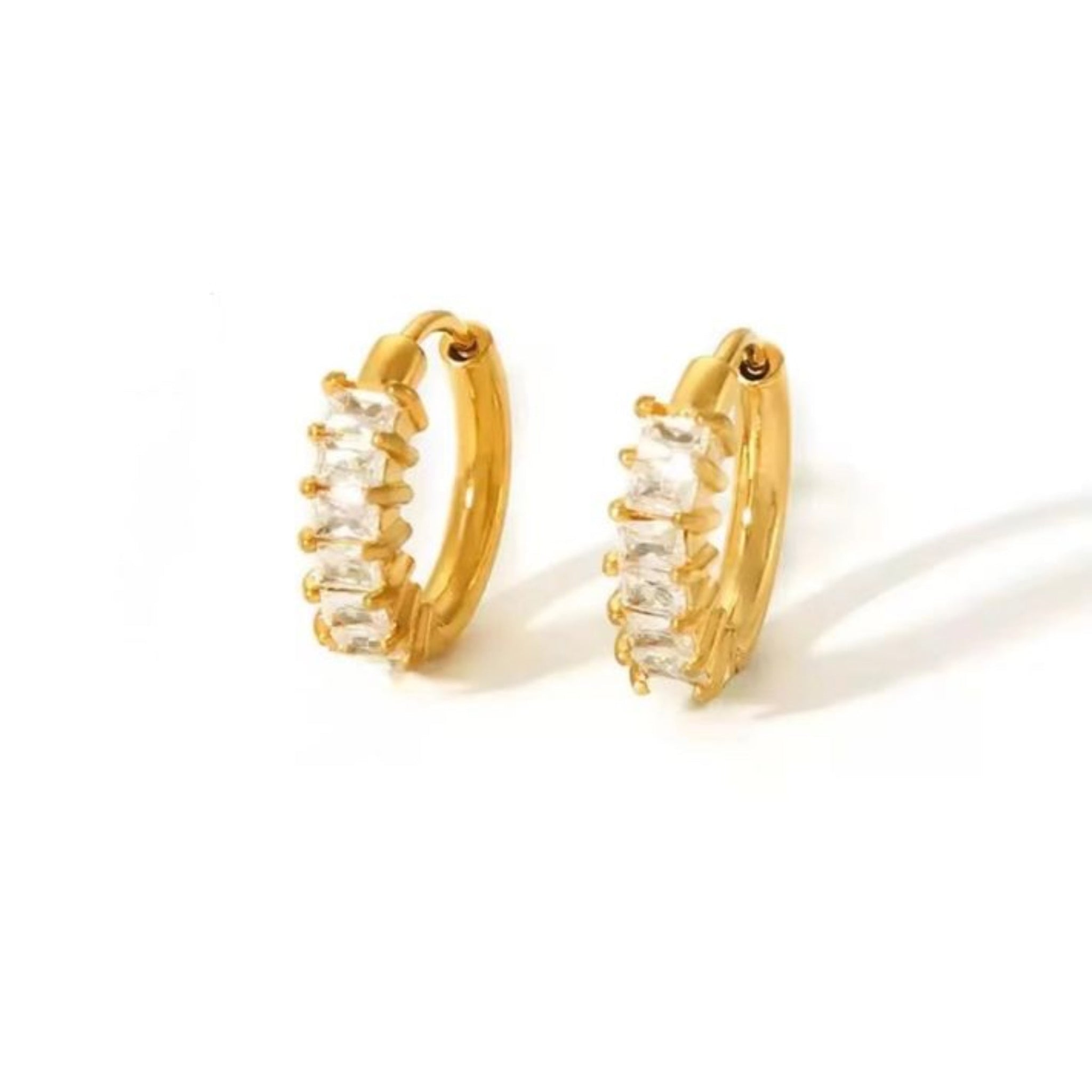 Gold hoop earrings with clear stones on a white background