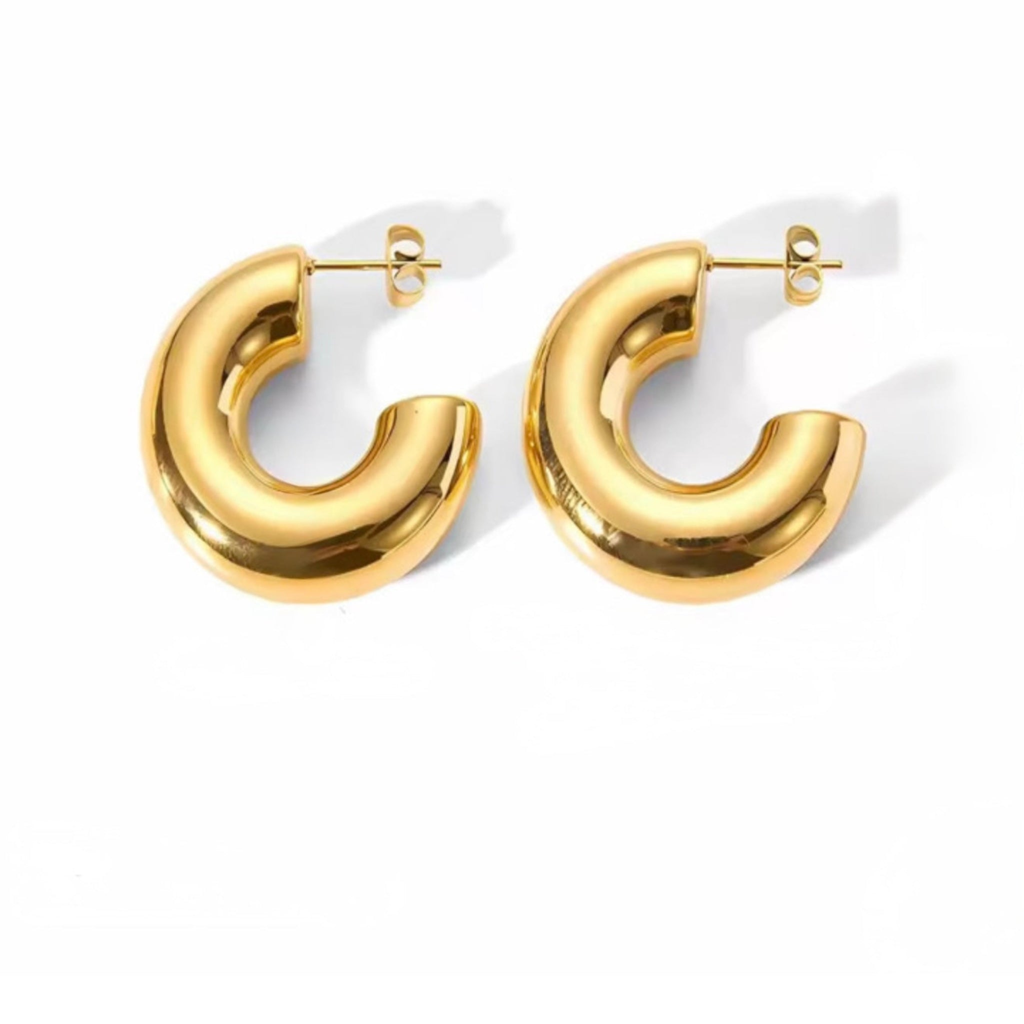 Gold hoop earrings on a white background