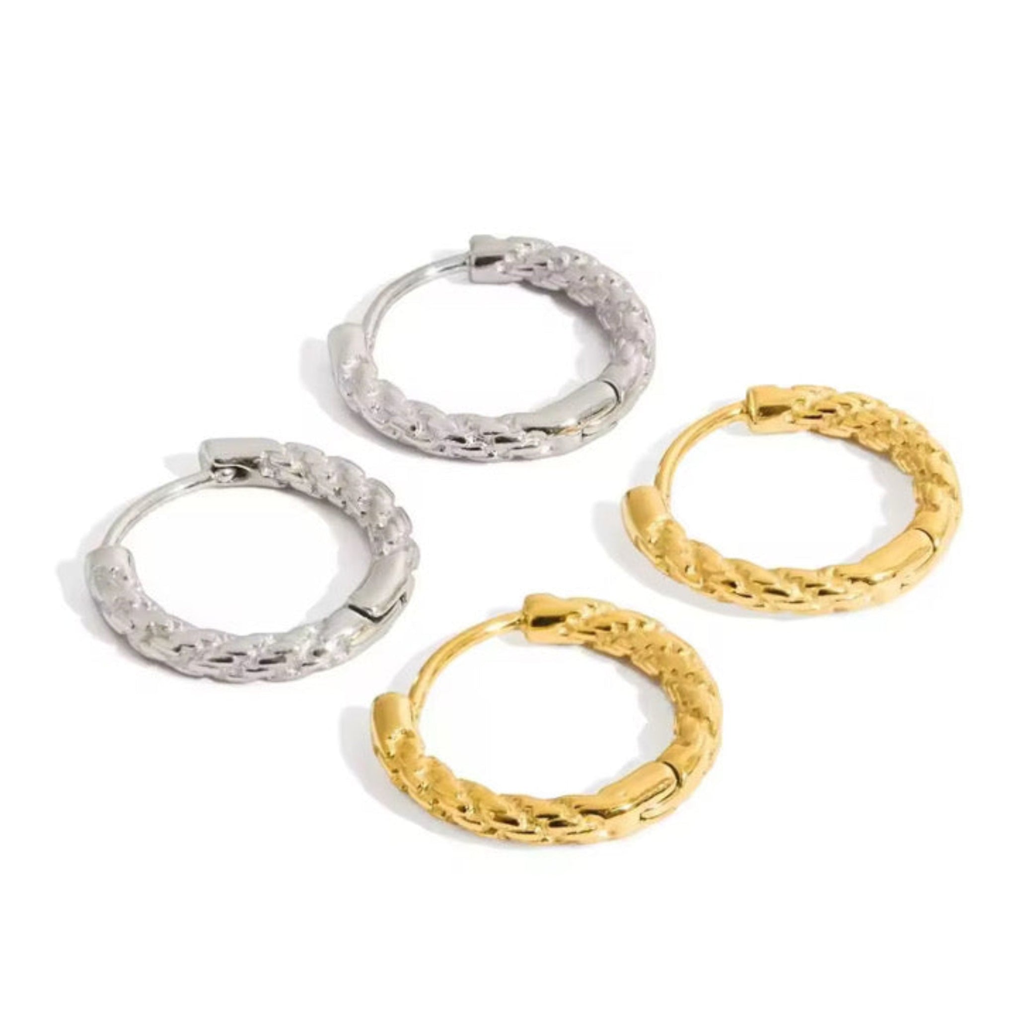 Gold and silver hoop earrings on a white background