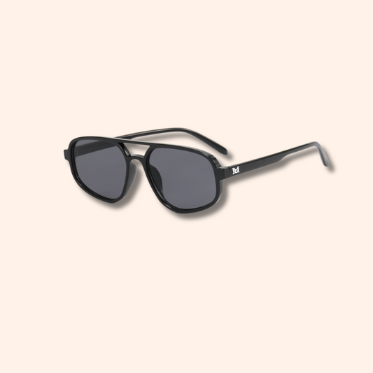 Black sunglasses with a brand logo on a beige background