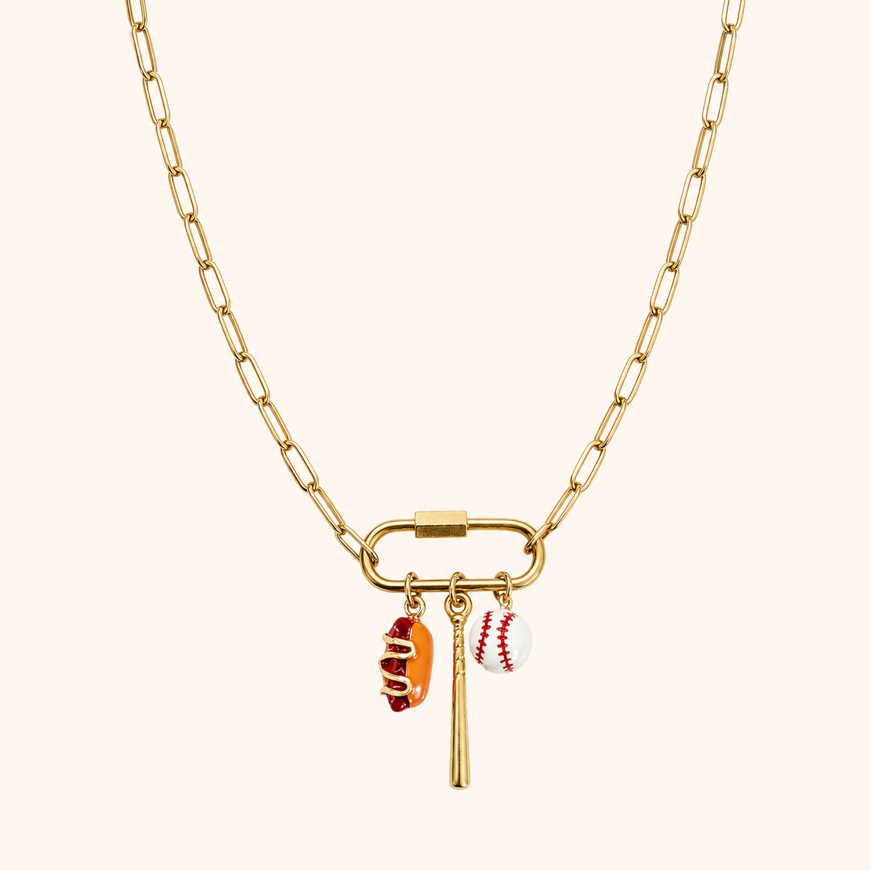 Gold paper clip chain necklace with carabiner clip and three charms