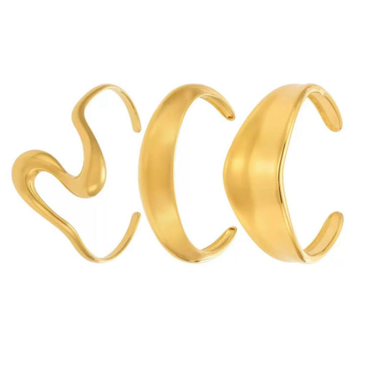 Three gold Bangles on a white background