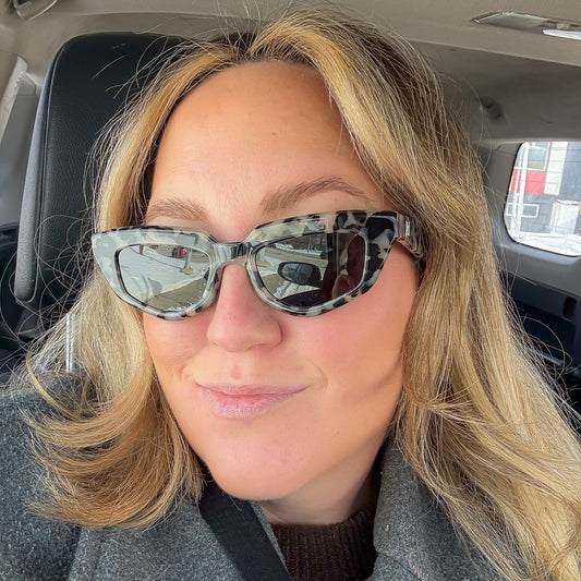 Person wearing sunglasses inside a vehicle