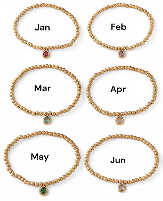 Set of six gold bracelets with gemstones labeled for each month.