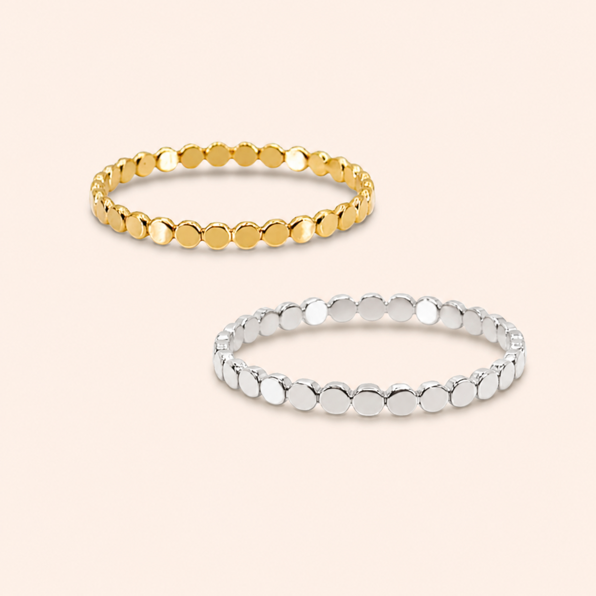 Two beaded metal rings, one gold and one silver, displayed on a light beige background.