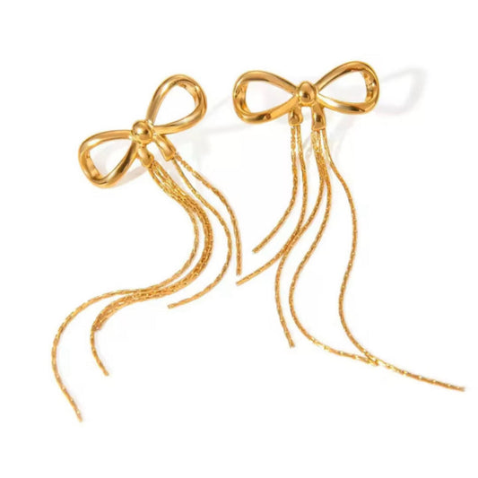 Gold bow-shaped earrings with tassels on a white background