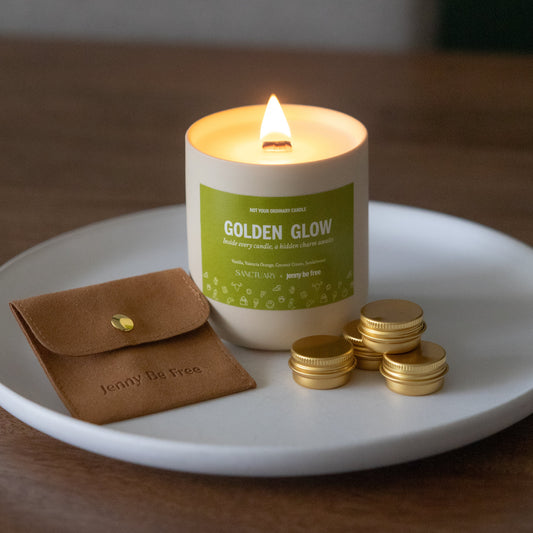 Candle labeled 'Golden Glow' on a white plate with a brown pouch and gold coins.