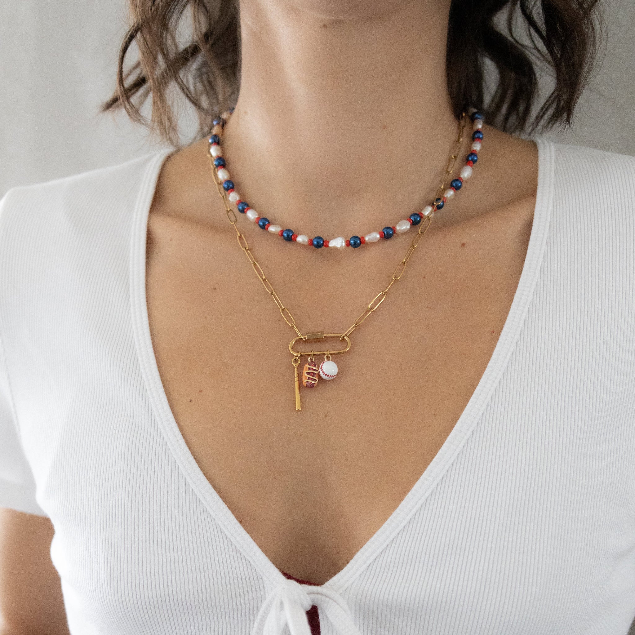Necklace with sports pendants on it. 