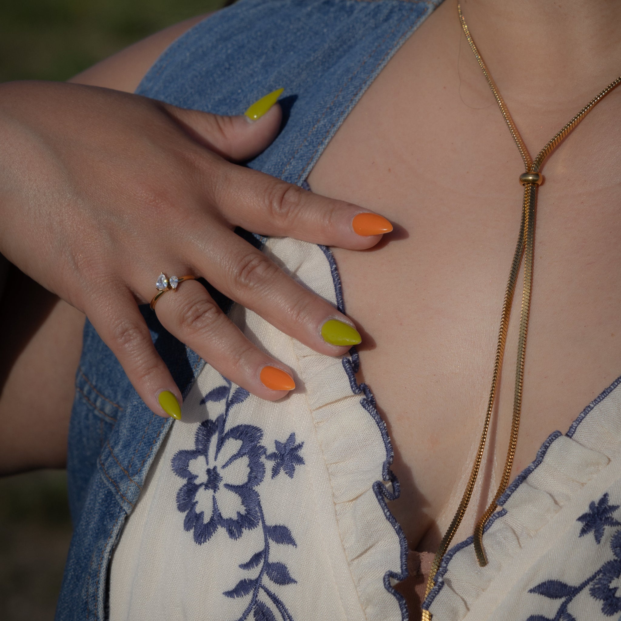 Close-up of a person wearing a necklace with a blurred background