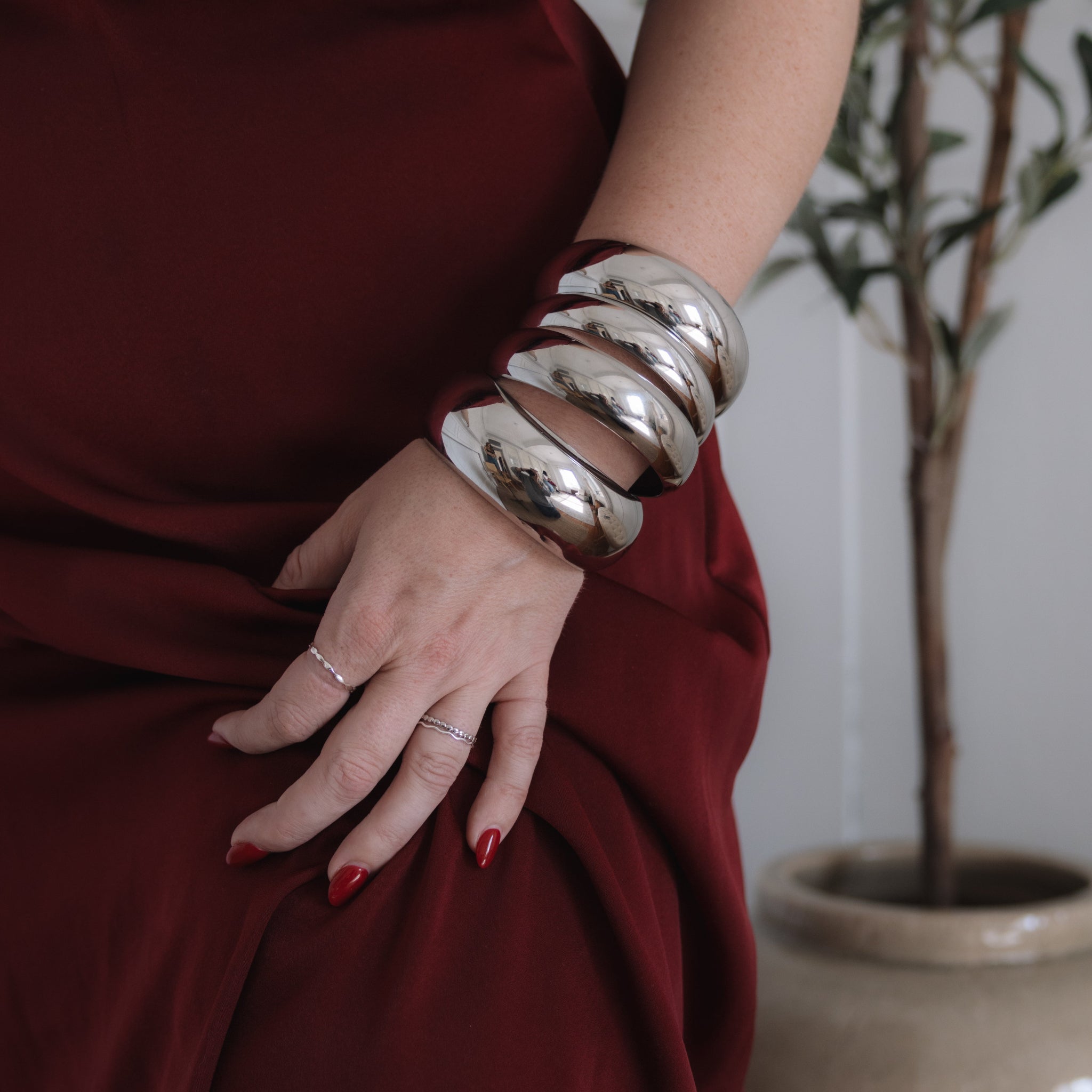 Girl wearing multiple silver bangles 
