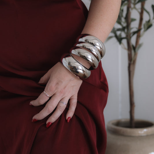 Girl wearing multiple silver bangles 