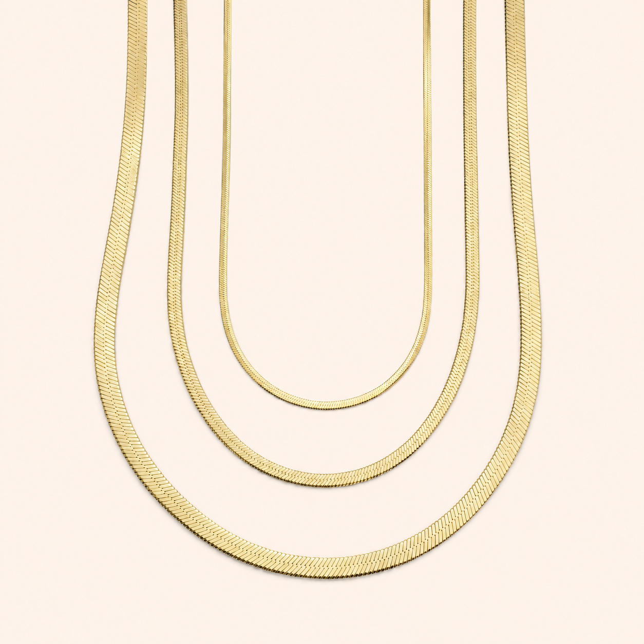 Gold herringbone necklaces in 2mm, 3mm and 4mm widths for layering