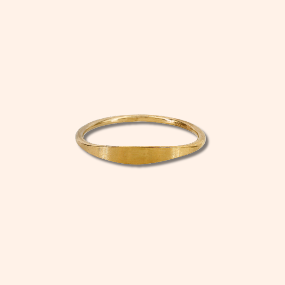 Gold ring on a beige background