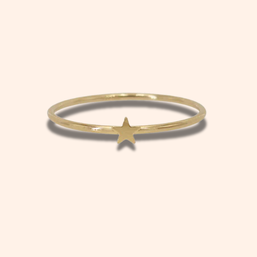 Gold ring with a star on a white background