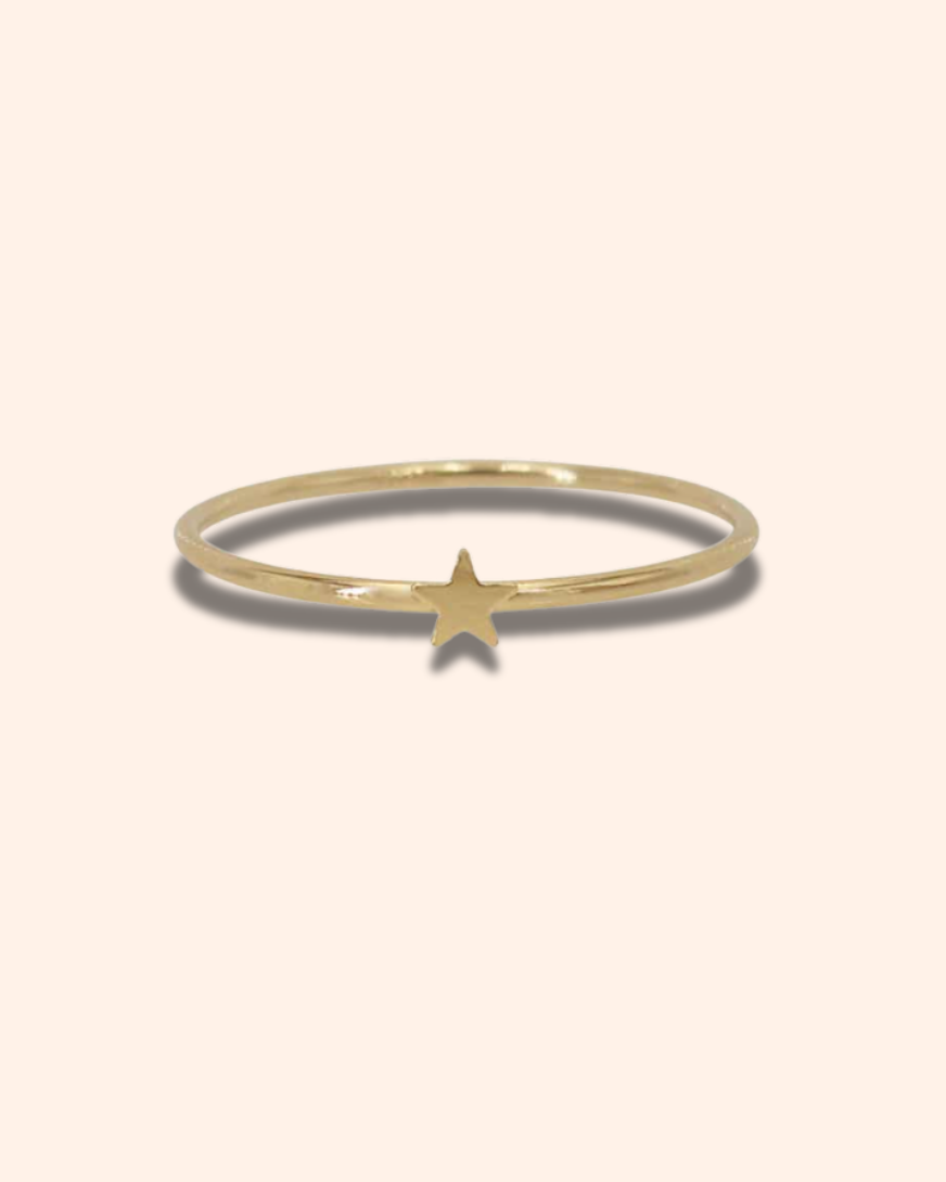 Gold ring with a star on a white background