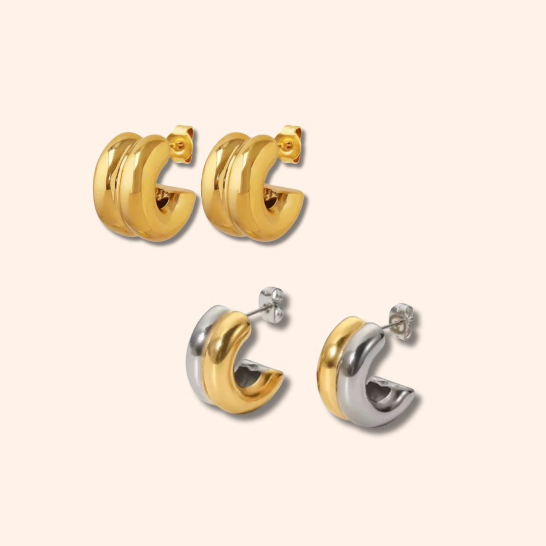 Pair of gold hoop earrings on a beige background