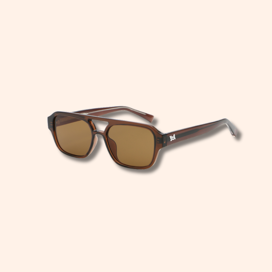 Sunglasses with brown lenses and tortoiseshell frame on a beige background