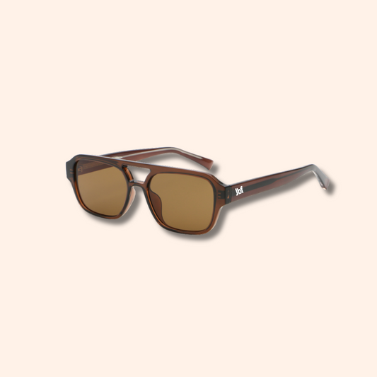 Sunglasses with brown lenses and tortoiseshell frame on a beige background