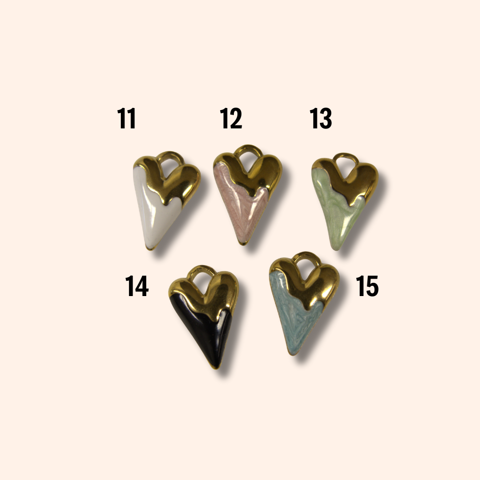 Set of five heart-shaped charms in various colors on a beige background