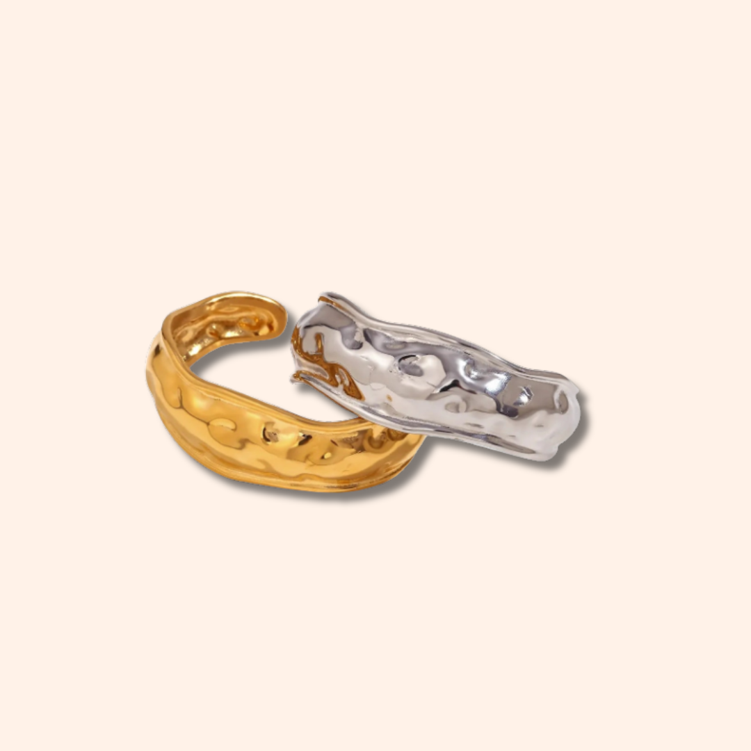 Gold and silver ring on a beige background