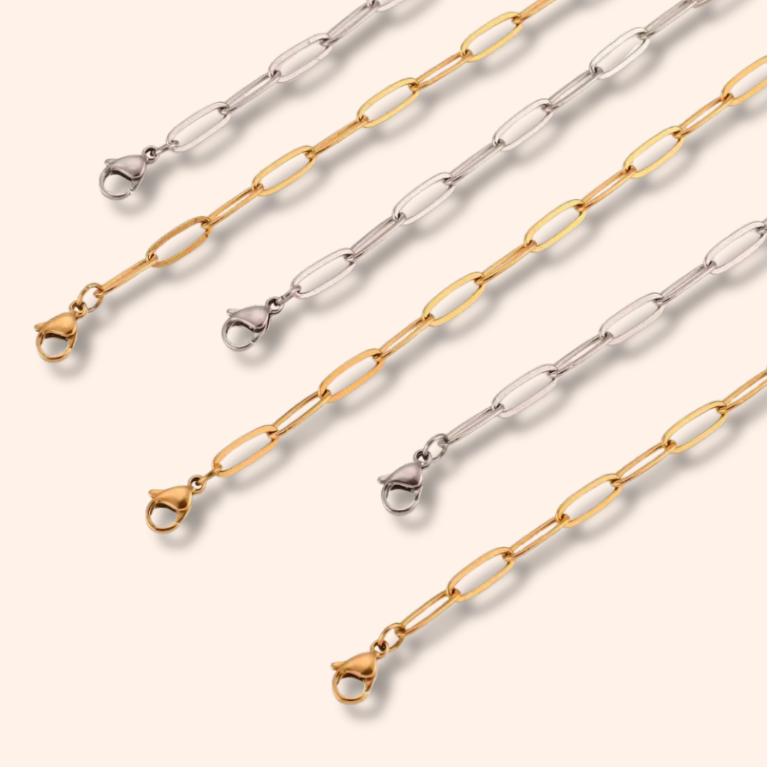 Three gold and silver chain necklaces on a white background
