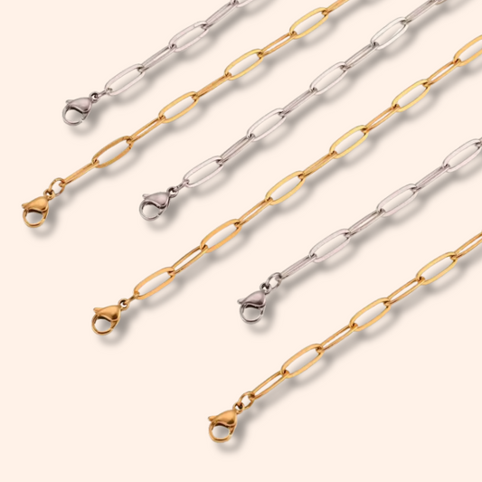 Three gold and silver chain necklaces on a white background