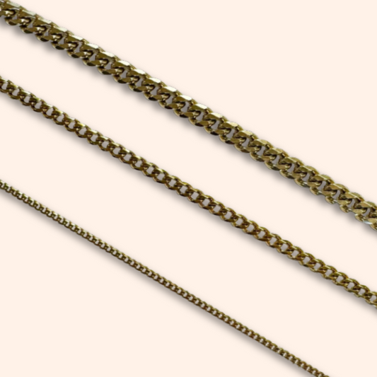 Two gold chains on a white background