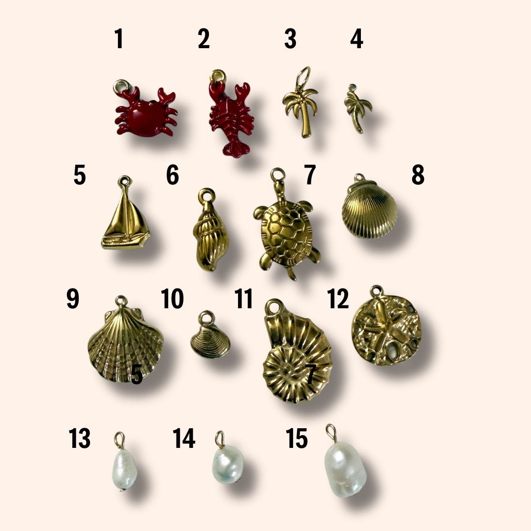 Collection of various jewelry charms on a beige background