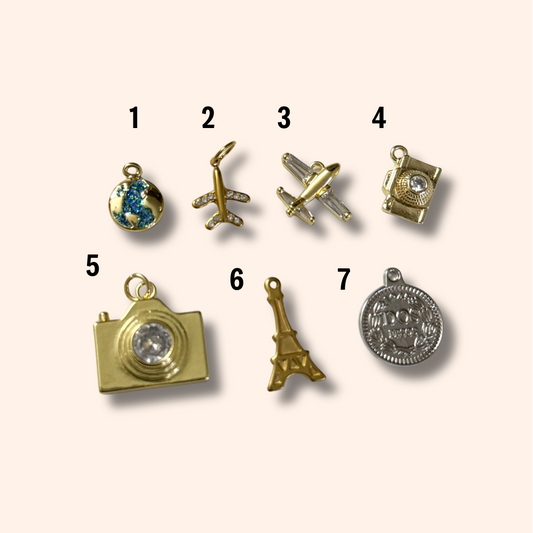 Collection of various gold and silver charms on a white background