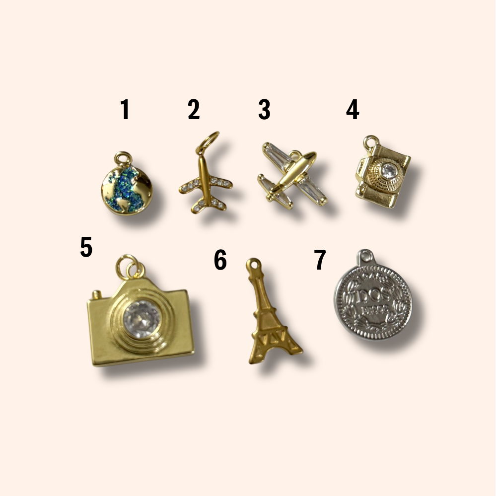 Collection of various gold and silver charms on a white background