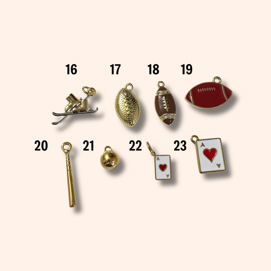 Collection of various small charms on a white background