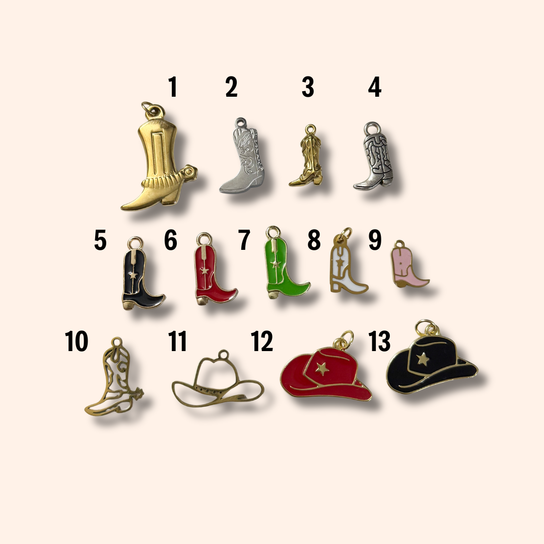 Collection of cowboy boot and hat charms on a beige background