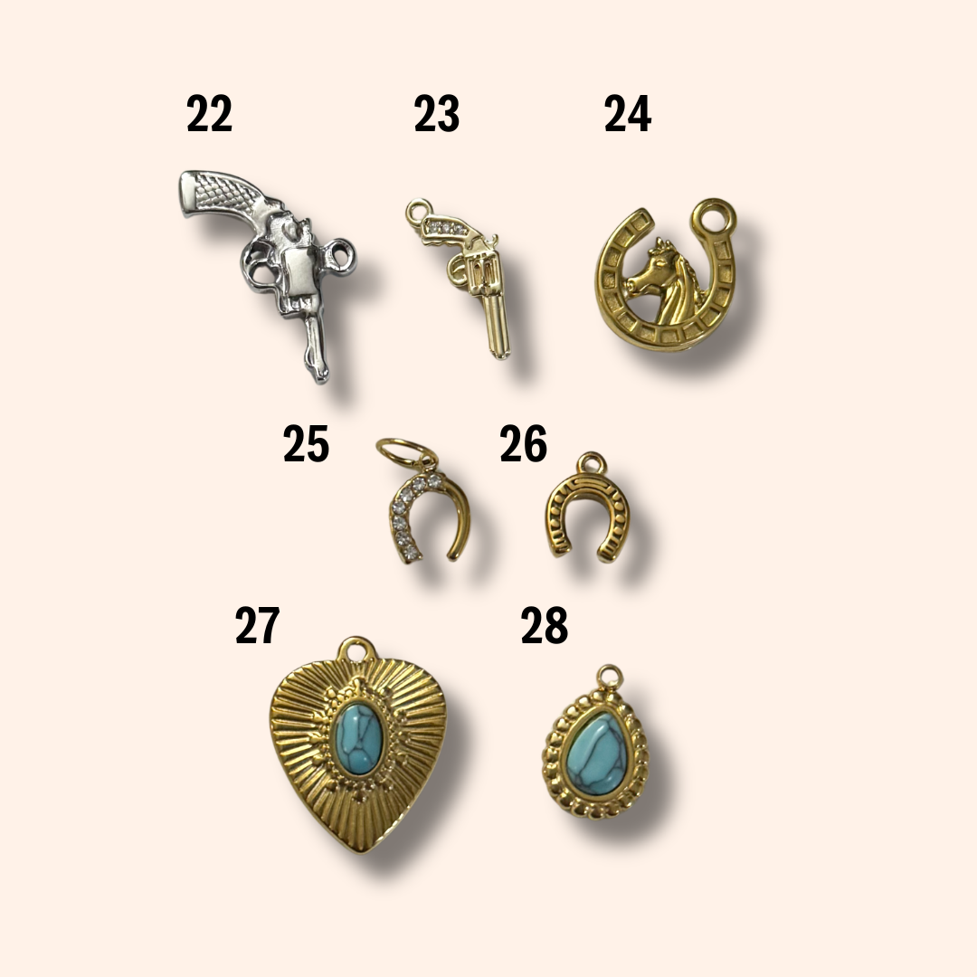 Collection of various jewelry charms on a beige background