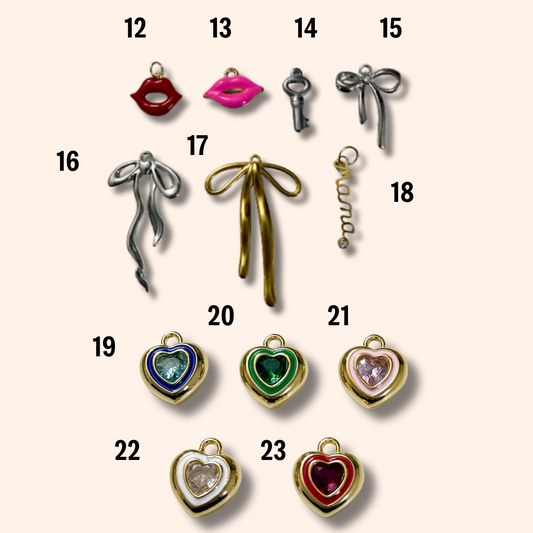 Collection of various jewelry charms on a beige background