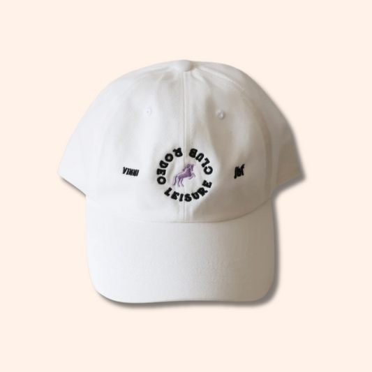 White cap with black text and logo on a beige background