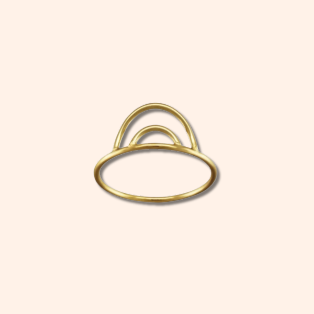 Gold ring with a minimalist design on a beige background