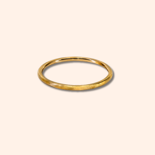 Gold ring on a beige background