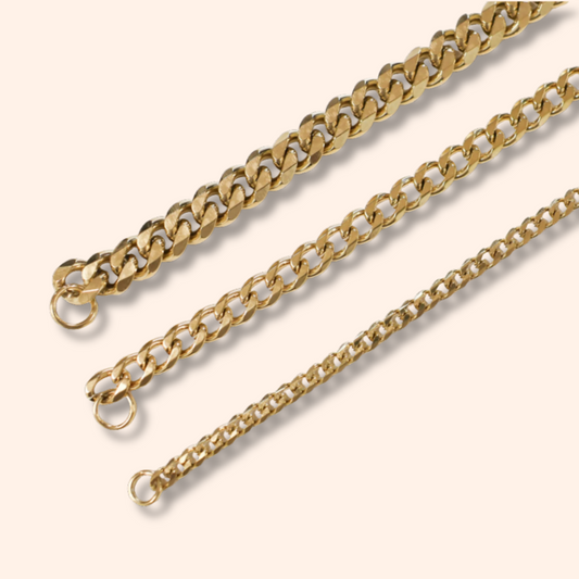 Two gold chains on a light beige background