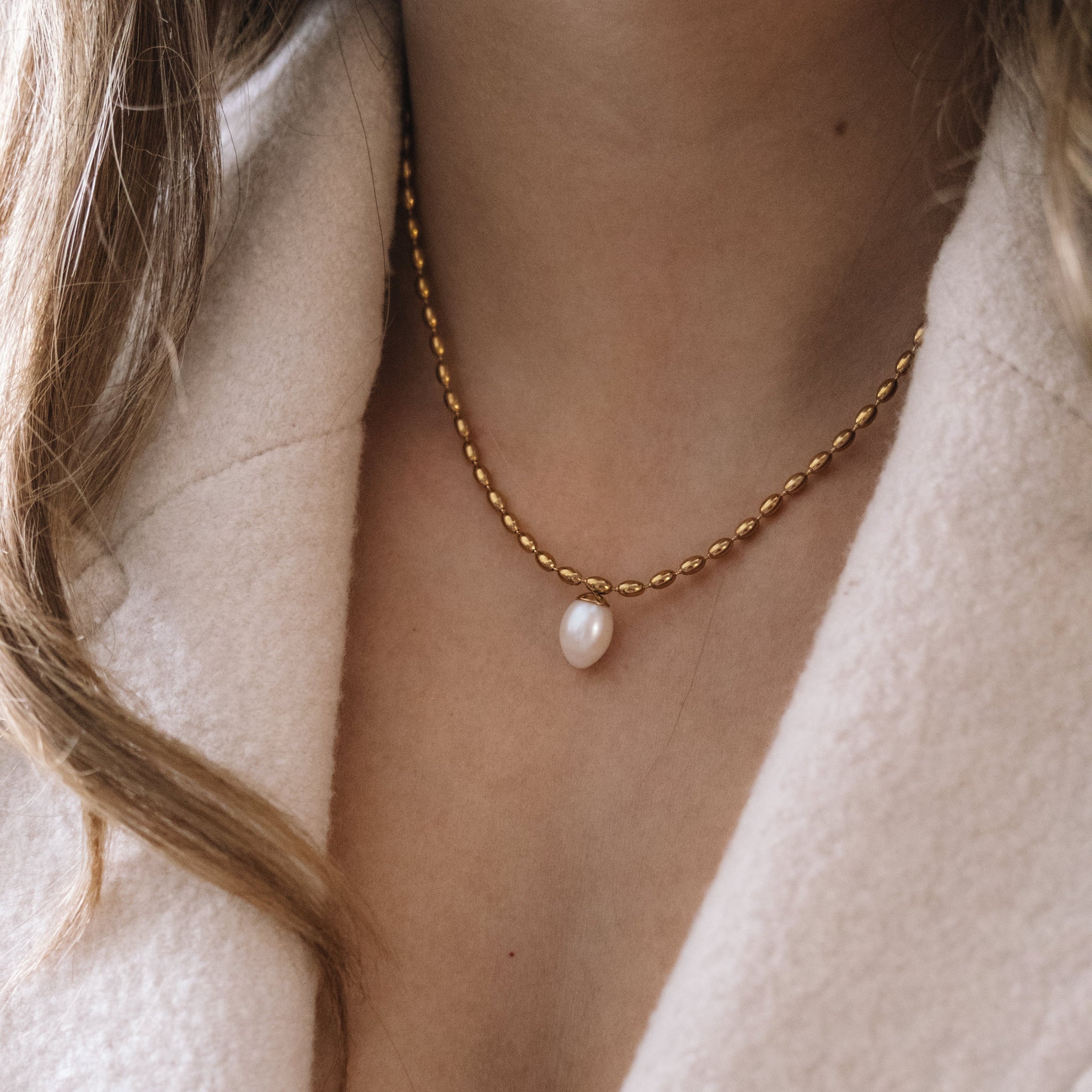 Girl wearing pearl necklace