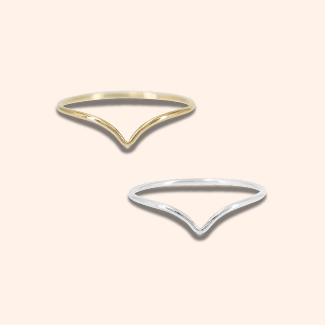Two gold and silver open ring designs on a light beige background