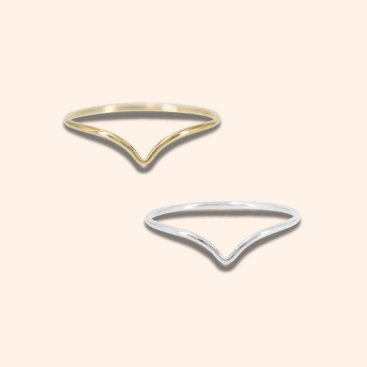 Two gold and silver open ring designs on a light beige background