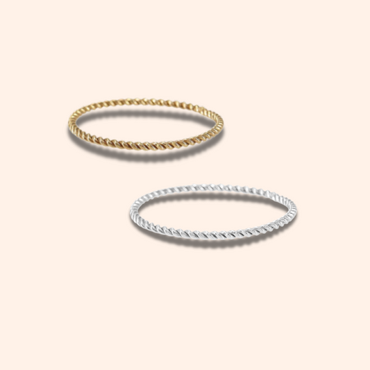 Two gold rings on a light beige background