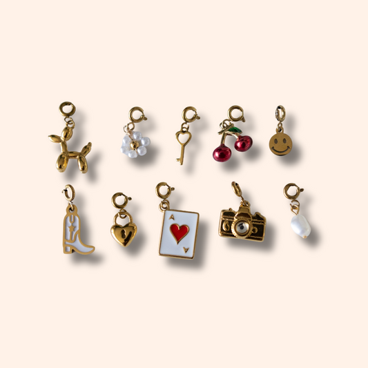 Collection of various small charms on a beige background