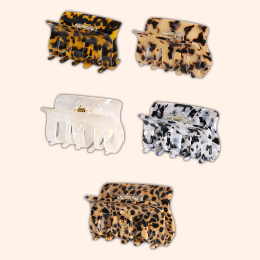 Set of five hair clips with leopard print, clear, and cow print designs on a white background.