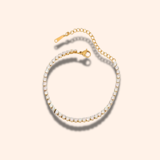 Gold and silver beaded bracelet on a light beige background