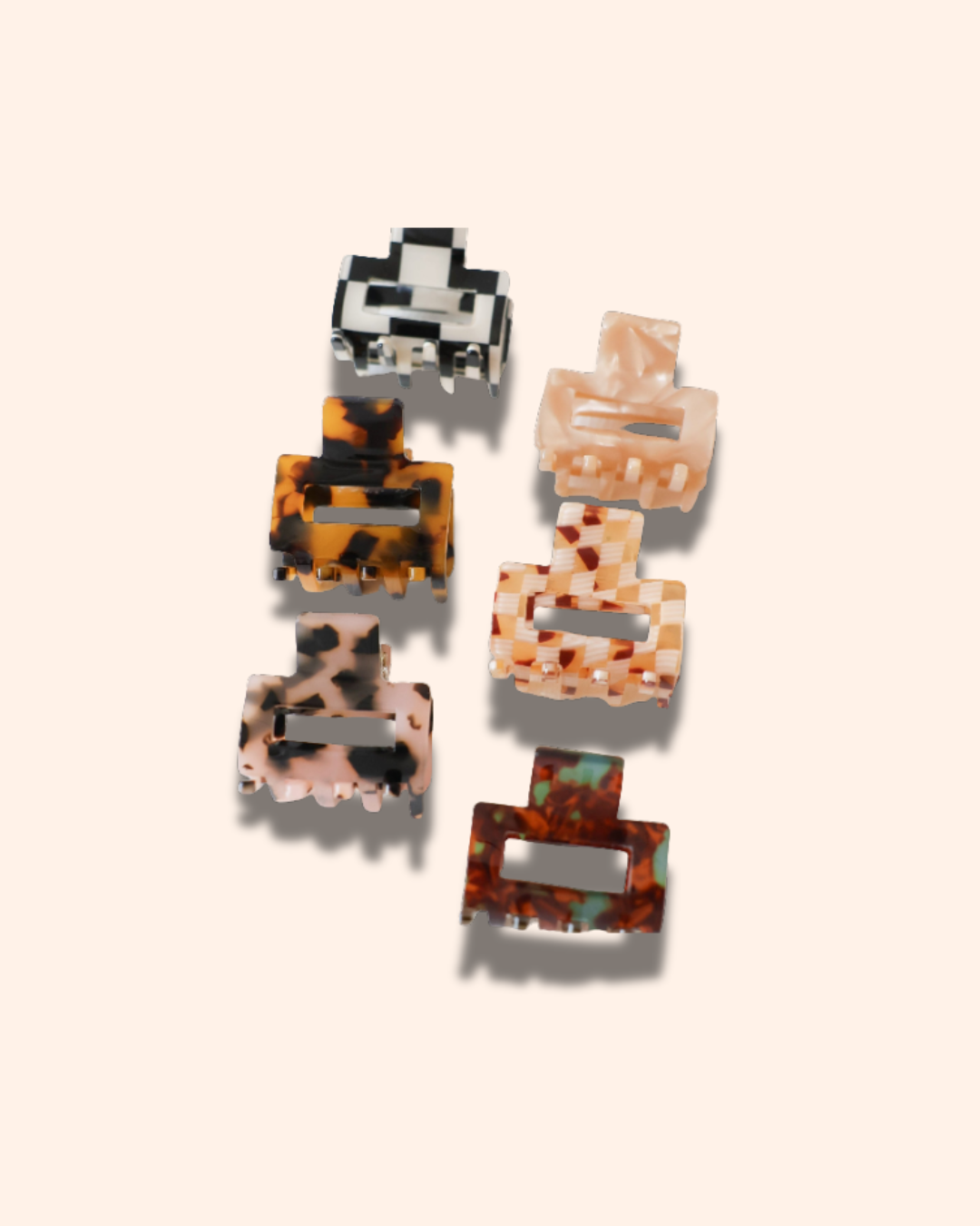 Set of six patterned hair clips on a light beige background