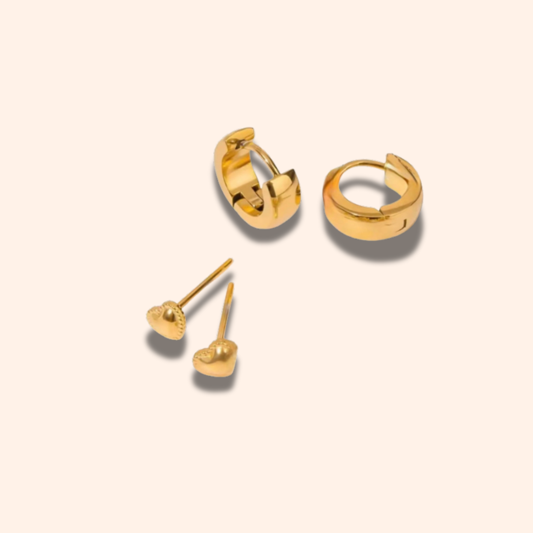 Set of gold hoop earrings and heart-shaped stud earrings on a beige background