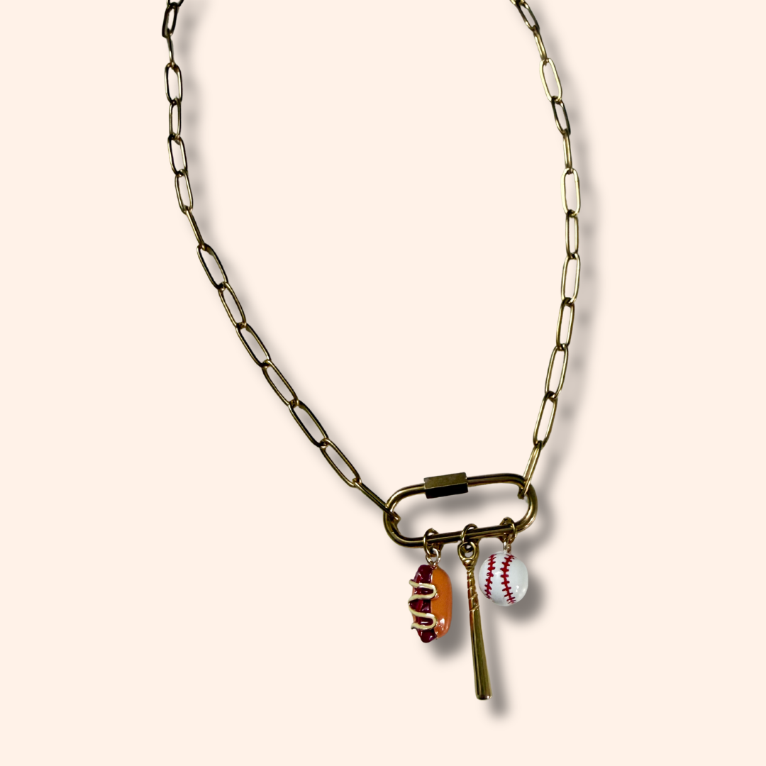 Necklace with sports-themed charms on a beige background