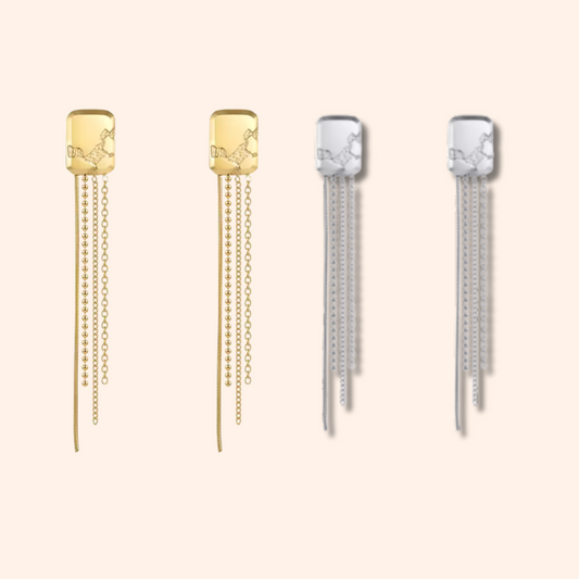 Pair of gold and silver tassel earrings on a white background