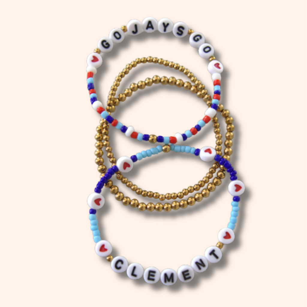 Set of beaded bracelets with lettered beads on a light background